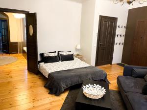 a bedroom with a bed and a couch at Doma square apartment 2, in the heart of Old town in Riga
