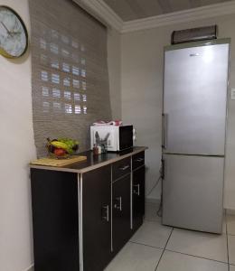 a kitchen with a refrigerator and a counter with a microwave at Lime Court house in Rosslyn