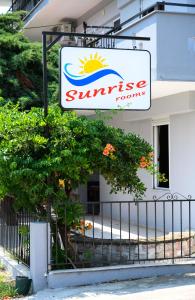 a sign for a sun rise rooms at Sunrise2 in Paralia Katerinis