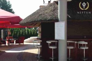 a bar with stools in front of a restaurant at Hotel Jastrzębia Góra in Jastrzębia Góra