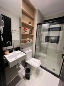 a bathroom with a shower and a toilet and a sink at Praia do Forte - Villa do Lago in Praia do Forte