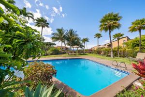 a swimming pool in a yard with palm trees at Wailea Ekolu 102 - Molokini Views, Split AC in Wailea