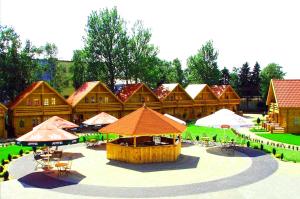 a building with tables and umbrellas in front of it at Hotel Jastrzębia Góra in Jastrzębia Góra