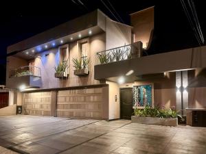 a house with potted plants on the side of it at Apartamento Estilo Industrial Moderno in Cali