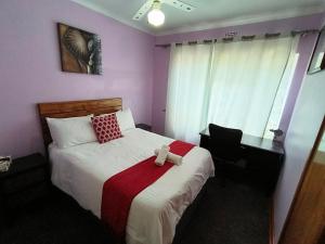 a hotel room with a bed and a desk and a bed sidx sidx at Sabie House -3 bedrooms, OR Tambo, Kempton Park, Johannesburg in Kempton Park