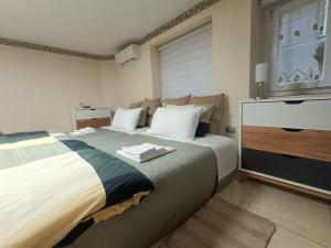 a bedroom with a large bed and a tv at Casa dei Sofisti in Lentini