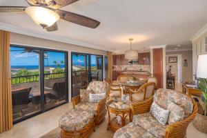 a living room with a table and chairs at Wailea Ekolu 407 - Renovated, Split AC, Ocean View in Wailea