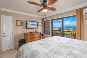 a bedroom with a bed and a large window at Wailea Ekolu 407 - Renovated, Split AC, Ocean View in Wailea