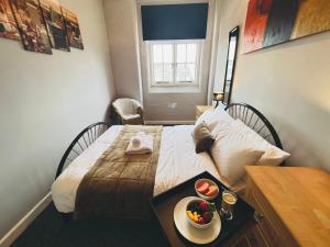 a bedroom with a bed and a table with a bowl of fruit on it at City Mill - Next to Town Centre Shopping and Restaurants - Free Parking in Burton upon Trent
