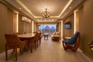 a dining room with a table and chairs at Pyramids Charm Hotel in Cairo