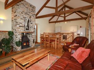 a living room with a couch and a fireplace at Duck House in Bude