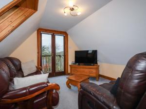 a living room with a couch and a television at The Granary in Bude