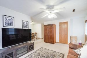 a living room with a large flat screen tv at Welcoming Condo in Davenport Central Location! in Davenport