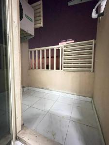 an empty room with a window and a tiled floor at 1BHK Sharjah Fully Furnished in Sharjah