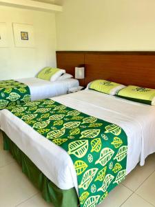 two beds sitting next to each other in a room at Hotel Village Porto de Galinhas - Apartamento 215 in Porto De Galinhas