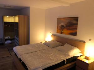 a bedroom with a large bed with two pillows at Fewo Rhein-Lahn Penthouse OG3-1 in Lahnstein