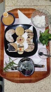 a tray with a plate of food on a table at Hôtel Restaurant BOUGAFER in Oulad Akkou