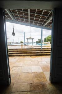 an open door to a patio with a view of the water at Bellevie Experience in Cascavel