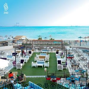 - un groupe de chaises et de tables sur une plage dans l'établissement LUSINDA HOTEL MANAGEMENT BY ZAD, à Suez