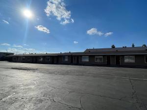 an empty parking lot in front of a building at CoachLight Motel in Hemet
