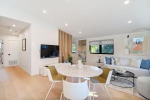 a living room with a table and a couch at Dazzling Modern Home Close to Downtown Palo Alto and Stanford in Menlo Park