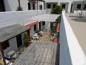 a balcony of a building with tables and chairs at Aeolos Hotel Apartments in Gythio