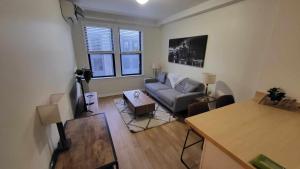 a living room with a couch and a table at Prime City Center Location! 2BR Near Everything! in Detroit
