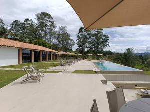 a patio with chairs and a swimming pool at Mountains Of Hope in Rionegro
