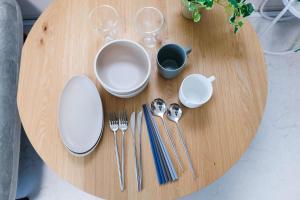a wooden table with plates and utensils on it at Seaside Tamachi - Vacation STAY 15740 in Tokyo