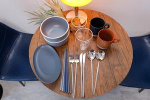 a wooden table with utensils on top of it at Seaside Tamachi - Vacation STAY 15579 in Tokyo