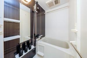 a bathroom with a sink and a mirror at Seaside Tamachi - Vacation STAY 15583 in Tokyo