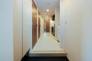 a hallway of a house with white walls at Seaside Tamachi - Vacation STAY 15579 in Tokyo