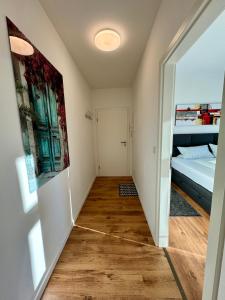 a hallway of a room with a bed and a door at Schicke Wohnung im grünen Hinterhof in Schwerin