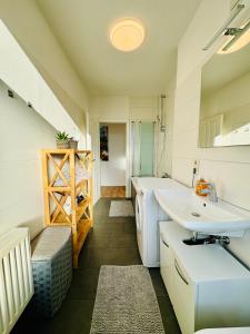 a bathroom with a sink and a toilet in it at Schicke Wohnung im grünen Hinterhof in Schwerin