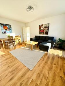 a living room with a couch and a table at Schicke Wohnung im grünen Hinterhof in Schwerin