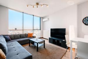 a living room with a couch and a tv at Residence with Urban View 5 min to Optimum Mall in Istanbul