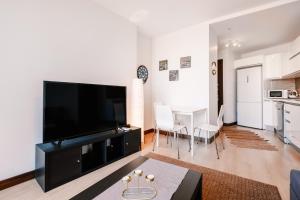 a living room with a large flat screen tv at Residence with Urban View 5 min to Optimum Mall in Istanbul
