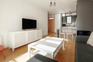 a living room with a white entertainment center with a tv at Flat with Terrace Close to Transit in Ankara in Ankara