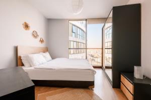 a bedroom with a bed and a large window at Residence with Urban View 5 min to Optimum Mall in Istanbul