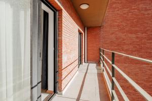 an empty corridor of a brick building with a balcony at Flat with Terrace Close to Transit in Ankara in Ankara