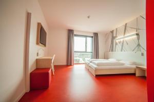 a hotel room with two beds and a window at havenhostel Cuxhaven in Cuxhaven