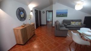 a living room with a couch and a table at O Miradouro in Angra do Heroísmo