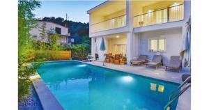 a swimming pool in front of a house at Villa Bamboo in Duće