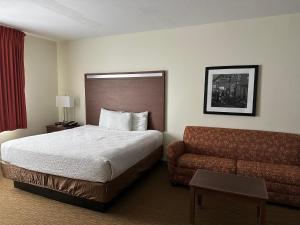 a hotel room with a bed and a couch at Expo Inn and Suites Belton Temple South I-35 in Belton