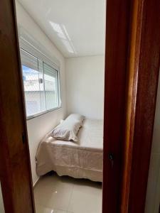 Una cama o camas en una habitación de Casa prox. a praia do Campeche