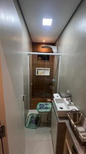 a small bathroom with a toilet and a sink at CASA DE PRAIA -Palmas Governador Celso Ramos, Sc in Governador Celso Ramos