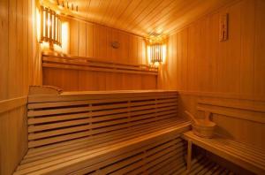an empty sauna with benches and lights in it at Willa Pod Łosiem in Krynica Zdrój