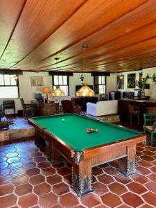a living room with a pool table in it at Sítio Mato Dentro in Atibaia