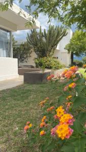 a garden with colorful flowers in front of a house at QHAWANA CABAÑAS & SUITES in La Rioja