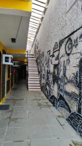 a hallway with graffiti on the side of a wall at Pousada Encantos de Maceió in Maceió